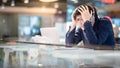 Young Asian business man feeling stressed while working with lap Royalty Free Stock Photo