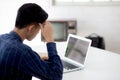 Young asian business man headache during working on laptop computer display blank screen with deadline at home. Royalty Free Stock Photo