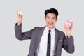 Young asian business man holding home and piggy bank for planning saving future, insurance agent and credit. Royalty Free Stock Photo