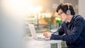 Young Asian business man listening to music while working with l Royalty Free Stock Photo