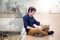 Young Asian business man listening to music while using laptop Royalty Free Stock Photo