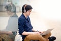 Young Asian business man listening to music while using laptop Royalty Free Stock Photo