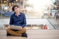 Young Asian business man listening to music while using laptop Royalty Free Stock Photo