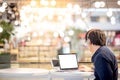 Young Asian business man listening to music while working with l Royalty Free Stock Photo