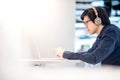 Young Asian business man listening to music while working with l Royalty Free Stock Photo