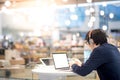 Young Asian business man listening to music while working with l Royalty Free Stock Photo