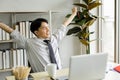 Young man relaxing at table in office during break Royalty Free Stock Photo