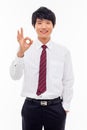 Young Asian business man showing okay sign.