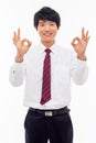Young Asian business man showing okay sign. Royalty Free Stock Photo