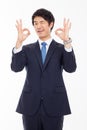 Young Asian business man showing okay sign. Royalty Free Stock Photo