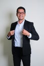 Young Asian business man showing proud gesture by touching his suit Royalty Free Stock Photo