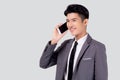 Young asian business man in suit talking on mobile phone isolated on white background. Royalty Free Stock Photo