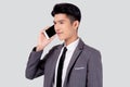 Young asian business man in suit talking on mobile phone isolated on white background. Royalty Free Stock Photo