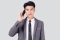 Young asian business man in suit talking on mobile phone isolated on white background. Royalty Free Stock Photo