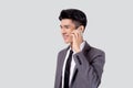 Young asian business man in suit talking on mobile phone isolated on white background. Royalty Free Stock Photo