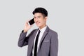 Young asian business man in suit talking on mobile phone isolated on white background. Royalty Free Stock Photo