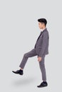 Young asian business man in suit walking movement isolated on white background, portrait of executive or manager. Royalty Free Stock Photo