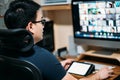 Young asian business man using computer for a online business meeting with his colleagues about plan in video conference. back Royalty Free Stock Photo