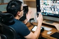 Young asian business man using computer for a online business meeting with his colleagues about plan in video conference. back Royalty Free Stock Photo