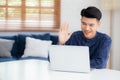 Young asian business man using laptop computer for video call online hello and communicate work from home. Royalty Free Stock Photo