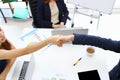 Young Asian business people shaking hands with partners after finishing a meeting. Handshake greeting deal concept Royalty Free Stock Photo