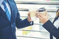 Young Asian Business people smiling and Relax holding a cup of coffee before go to work. Couple lover enjoy drinking coffee