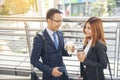 Young Asian Business people smiling and Relax holding a cup of coffee before go to work. Couple lover enjoy drinking coffee