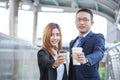 Young Asian Business people smiling and Relax holding a cup of coffee before go to work. Couple lover enjoy drinking coffee