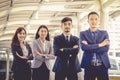 The young Asian business team stands with confidence and pride. Royalty Free Stock Photo