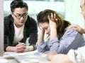 Young asian business woman appearing to be frustrated during a discussion in office