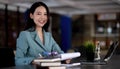 Young asian business woman beautiful charming smiling sitting working in office. Looking at camera Royalty Free Stock Photo