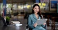 Young asian business woman beautiful charming smiling sitting working in office. Looking at camera Royalty Free Stock Photo