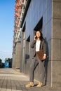 Young businesswoman talking on the phone and holding a laptop in her hands Royalty Free Stock Photo