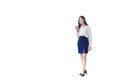 Young Asian business woman is going to office or workplace which she holds smartphone in her hands in city with business buildings Royalty Free Stock Photo
