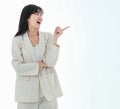 A young asian business woman has a big smile and place a finger close to her cheek, looking up to the side on copy space white Royalty Free Stock Photo