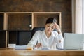 Young Asian business woman is having trouble controlling her online work in front of a laptop screen. Serious Asian Royalty Free Stock Photo