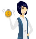 Young asian business woman holding alarm clock. Royalty Free Stock Photo