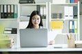 Young asian business woman or student working online on computer laptop. Royalty Free Stock Photo