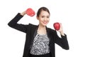 Young Asian business woman with red apple and dumbbells Royalty Free Stock Photo