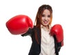 Young Asian business woman with red boxing gloves. Royalty Free Stock Photo