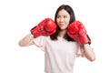 Young Asian business woman with red boxing gloves. Royalty Free Stock Photo