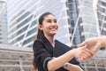 Young Asian business woman shaking hands with partners after finishing a meeting. Handshake greeting deal concept