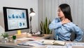 Young Asian Business woman sitting on the chair stretching herself and exercise for relaxation while working hard at office Royalty Free Stock Photo