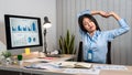 Young Asian Business woman sitting on the chair stretching herself and exercise for relaxation while working hard at office Royalty Free Stock Photo