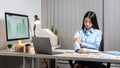 Young Asian Business woman sitting on the chair stretching herself and exercise for relaxation while working hard at office Royalty Free Stock Photo