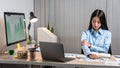 Young Asian Business woman sitting on the chair stretching herself and exercise for relaxation while working hard at office Royalty Free Stock Photo