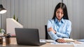 Young Asian Business woman sitting on the chair stretching herself and exercise for relaxation while working hard at office Royalty Free Stock Photo