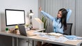 Young Asian Business woman sitting on the chair stretching herself and exercise for relaxation while working hard at office Royalty Free Stock Photo