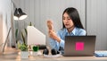 Young Asian Business woman sitting on the chair stretching herself and exercise for relaxation while working hard at office Royalty Free Stock Photo