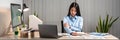 Young Asian Business woman sitting on the chair stretching herself and exercise for relaxation while working at office Royalty Free Stock Photo